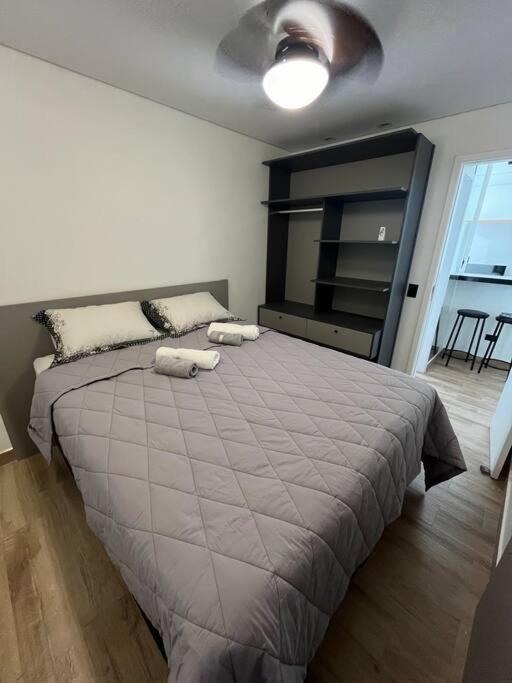 a bedroom with a large bed with two pillows on it at Apt próximo do metrô carrão in Sao Paulo
