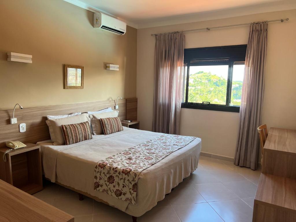 Cama ou camas em um quarto em Guararema Parque Hotel