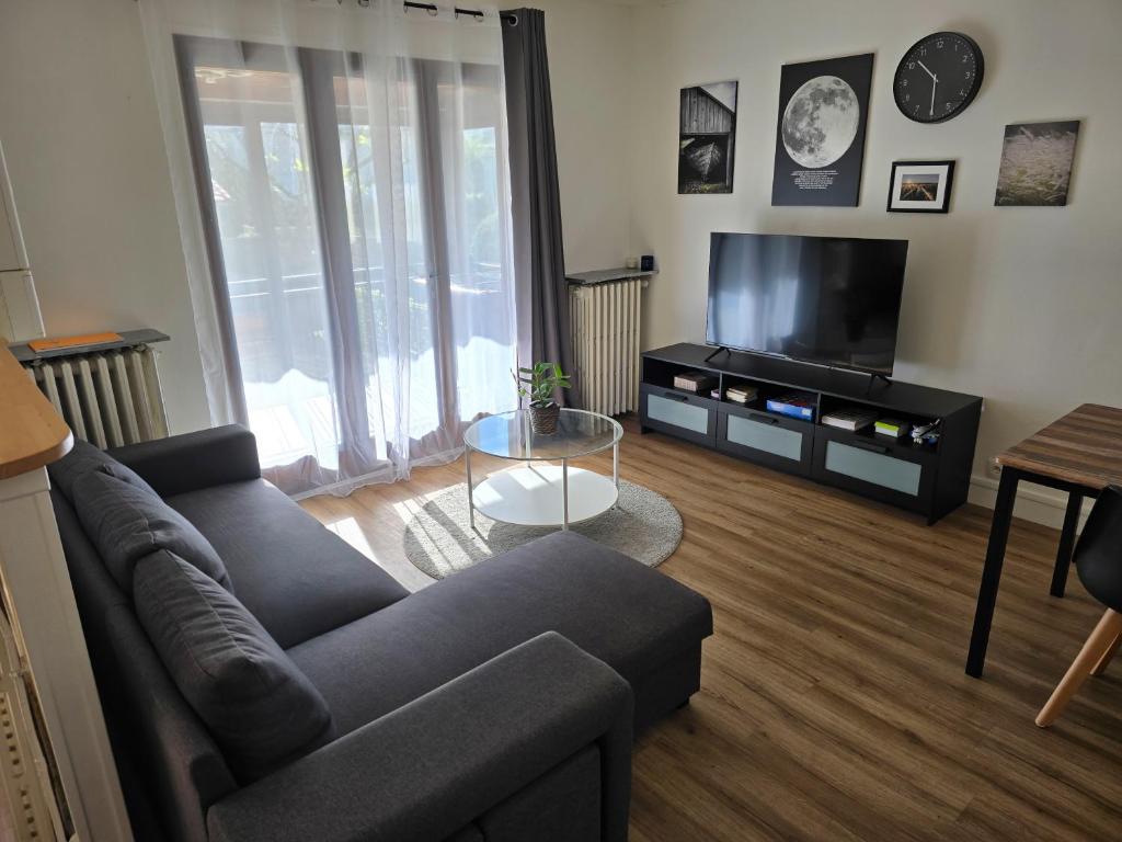 a living room with a couch and a flat screen tv at Maison Paris, Vallée Village, Disney & Astérix in Chelles