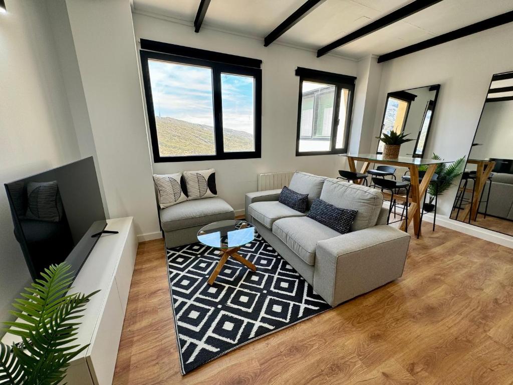 a living room with a couch and a table at Triplex Loft Mountain ZONA BAJA in Sierra Nevada