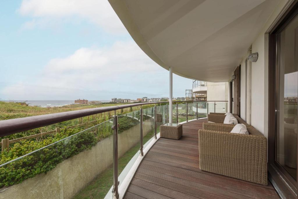 a balcony with chairs and a view of the ocean at Host & Stay - Sunset in Newquay