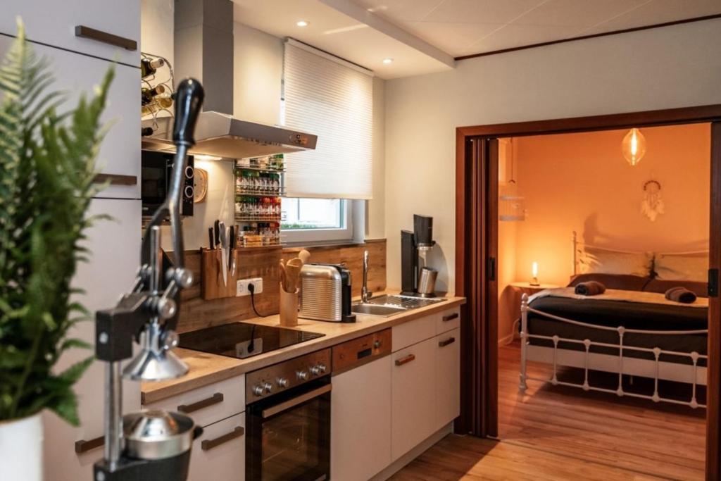 a kitchen with a sink and a bed in a room at Ferienhaus Spessartfeeling in Hasselroth