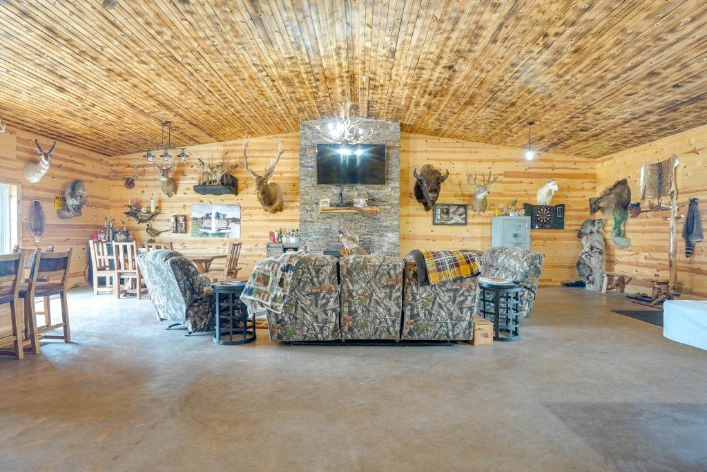 Una gran sala con sillas y una pared de piedra. en Hot Tub and Fire Pit Family Retreat in South Dakota, en Fedora