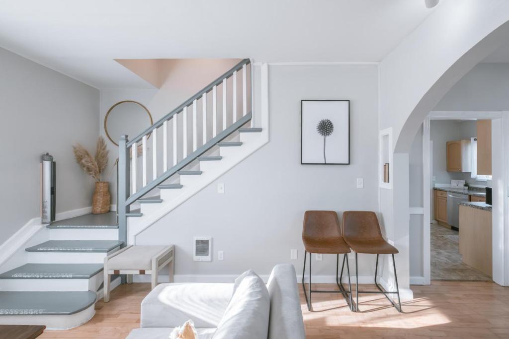 a living room with a staircase and a couch at 5 Bedroom House Cheerful Bungalow with AC Pet Friendly in Corvallis