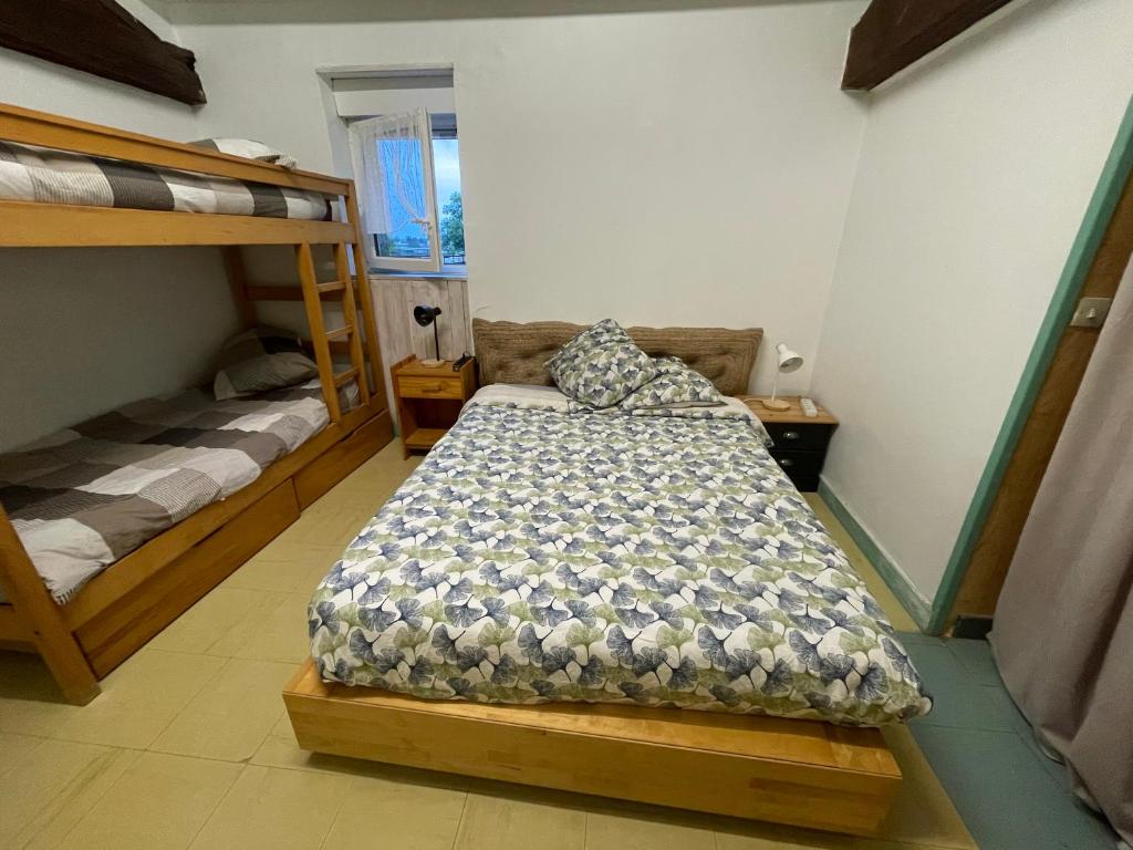 a bedroom with two bunk beds in a room at chambre 4 personnes avec entrée indépendante , grand parking, salle de bain, wc in Confolens