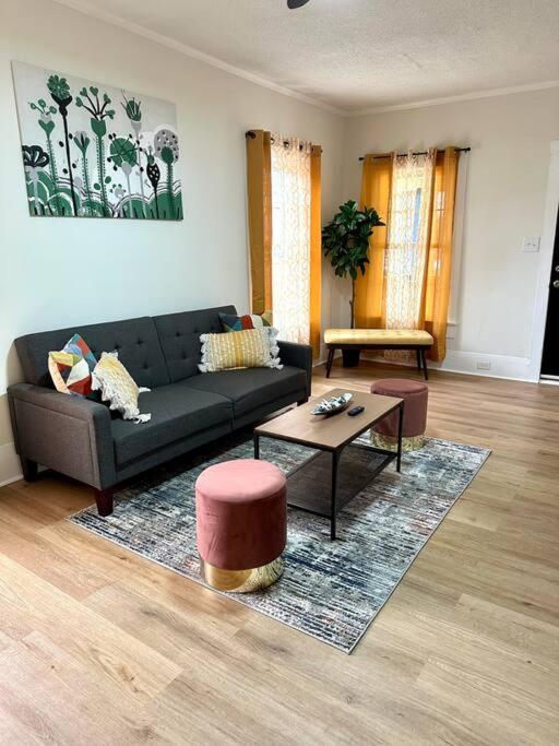 a living room with a black couch and a table at Beautiful Contemporary 2BDR in Concord