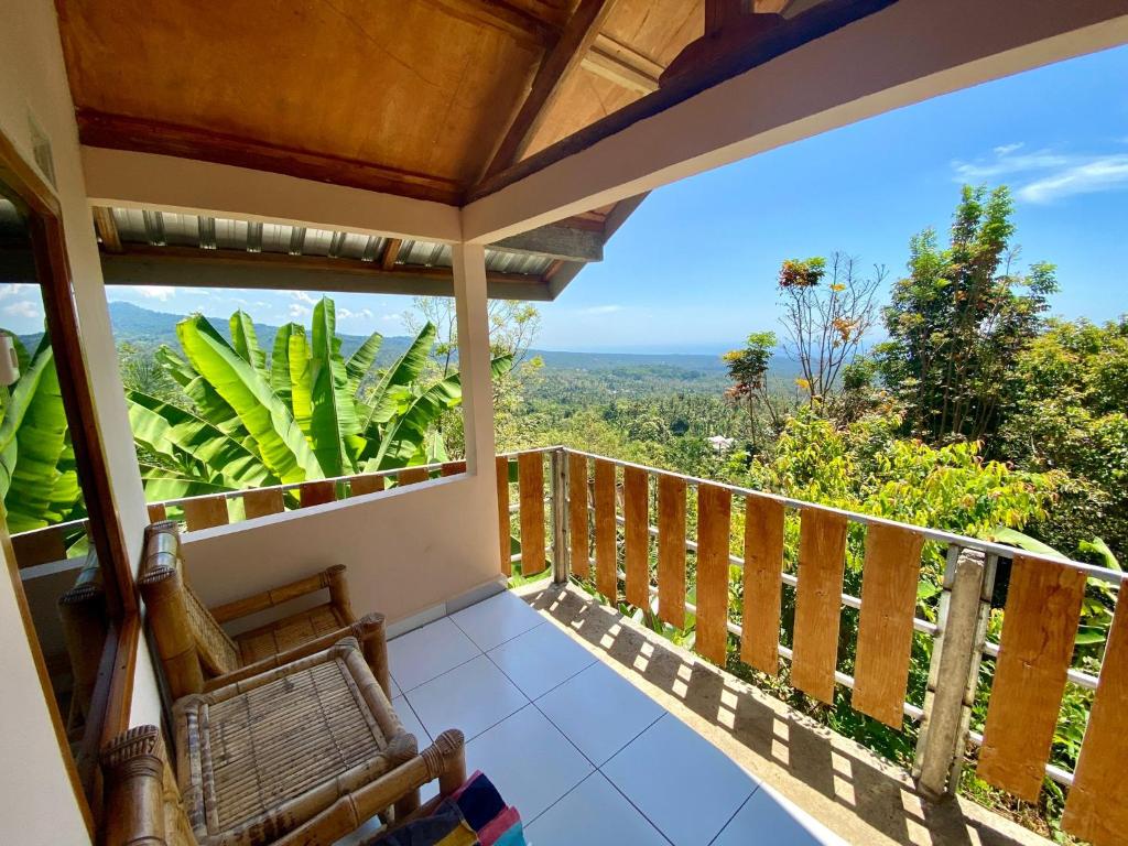 a balcony with a view of the jungle at Senaru sunset house in Senaru