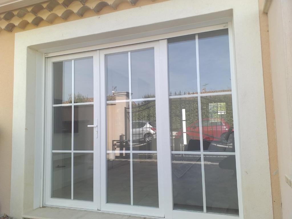 a window with a view of a parking lot at 2 Voyageurs - 1 Lit - Proche de toutes commodités in Peyrolles-en-Provence