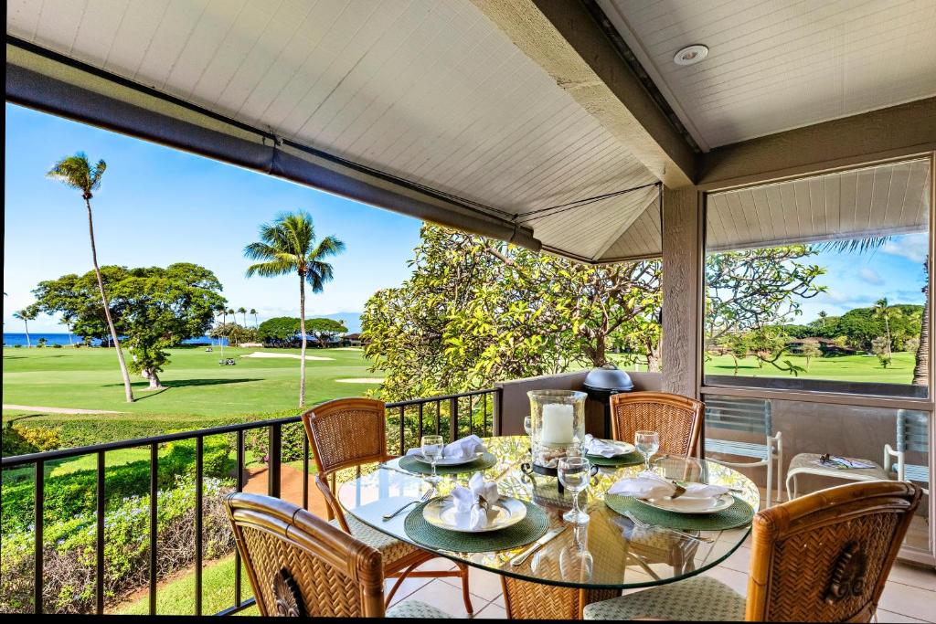 a dining room with a table and chairs on a balcony at Maui Eldorado Condo I204 in Kaanapali