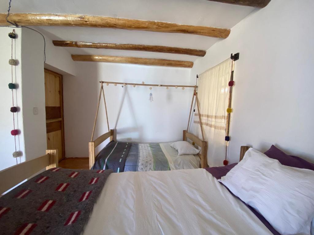 Postel nebo postele na pokoji v ubytování Colibri Wasi Pisac