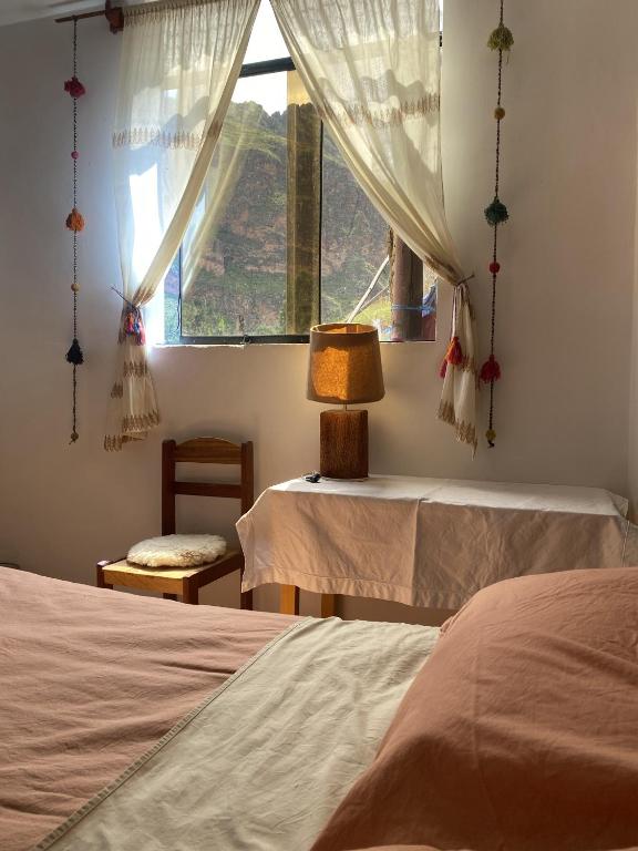 Postel nebo postele na pokoji v ubytování Colibri Wasi Pisac