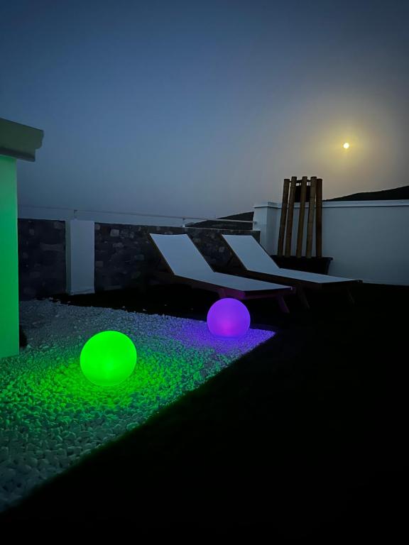 a room with green and purple lights on the ground at Umbertos Rooms in Jerzu