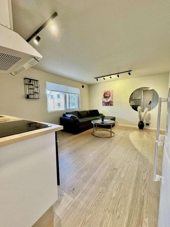 a living room with a couch and a table at Aurora Stay- Aurora garden Apartment in Tromsø