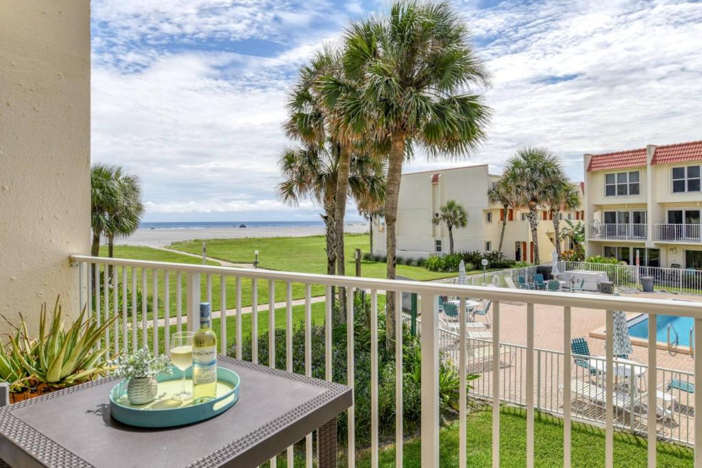a balcony with a table and a view of the ocean at Pier Point 17 in St. Augustine
