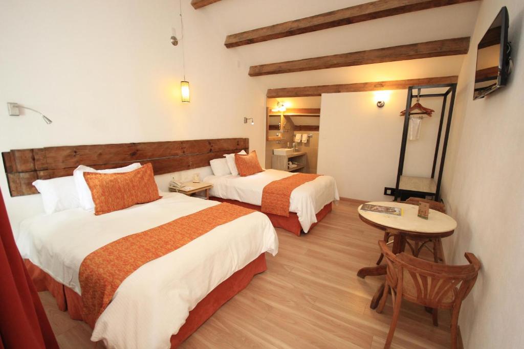 Postel nebo postele na pokoji v ubytování Hotel Ciudad Real Centro Historico