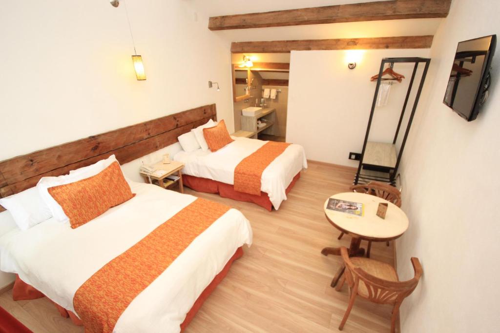 Postel nebo postele na pokoji v ubytování Hotel Ciudad Real Centro Historico