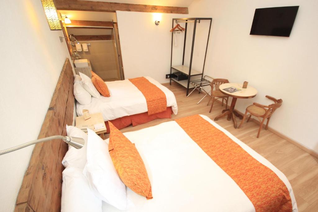 Postel nebo postele na pokoji v ubytování Hotel Ciudad Real Centro Historico