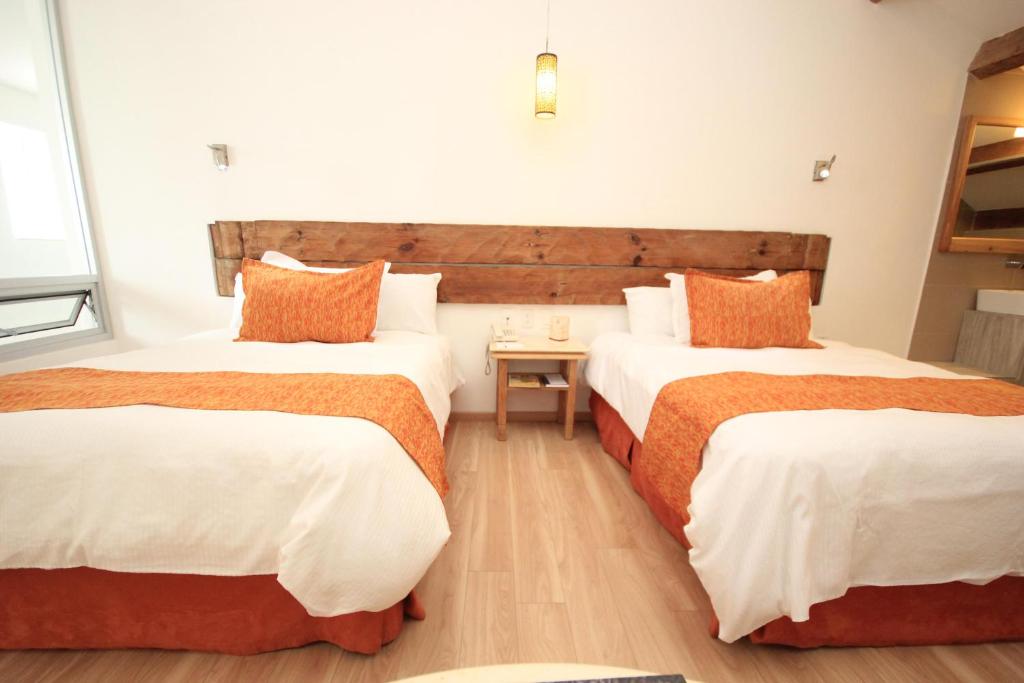 Postel nebo postele na pokoji v ubytování Hotel Ciudad Real Centro Historico