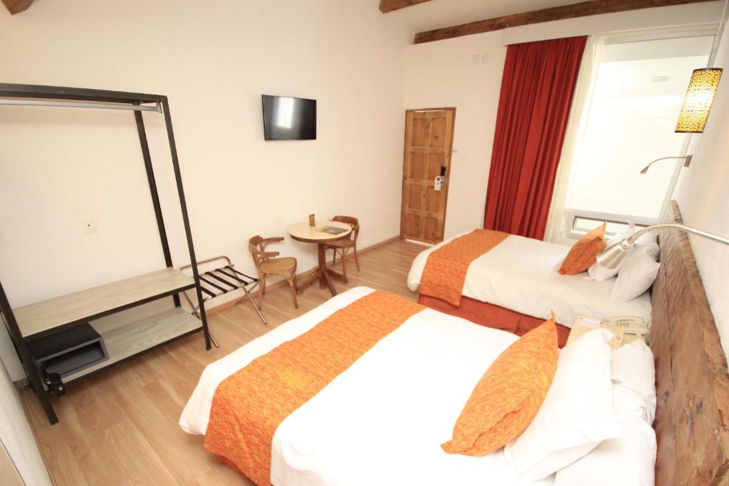 Postel nebo postele na pokoji v ubytování Hotel Ciudad Real Centro Historico