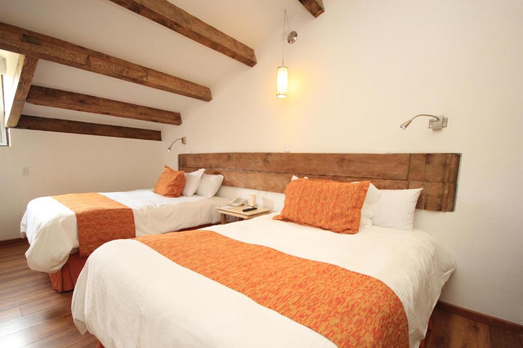 Postel nebo postele na pokoji v ubytování Hotel Ciudad Real Centro Historico