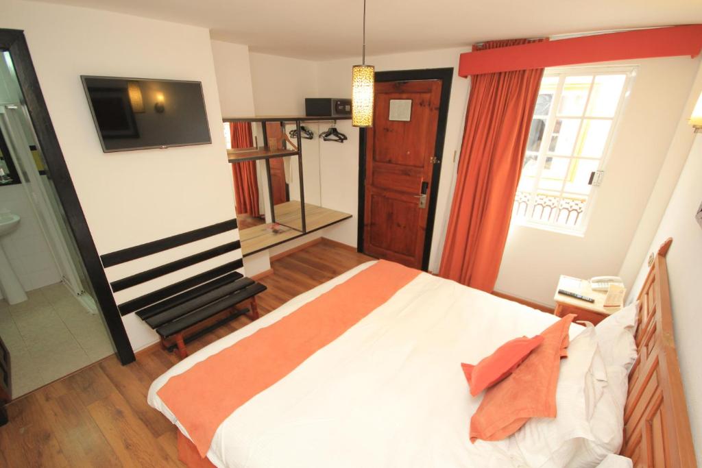 Postel nebo postele na pokoji v ubytování Hotel Ciudad Real Centro Historico