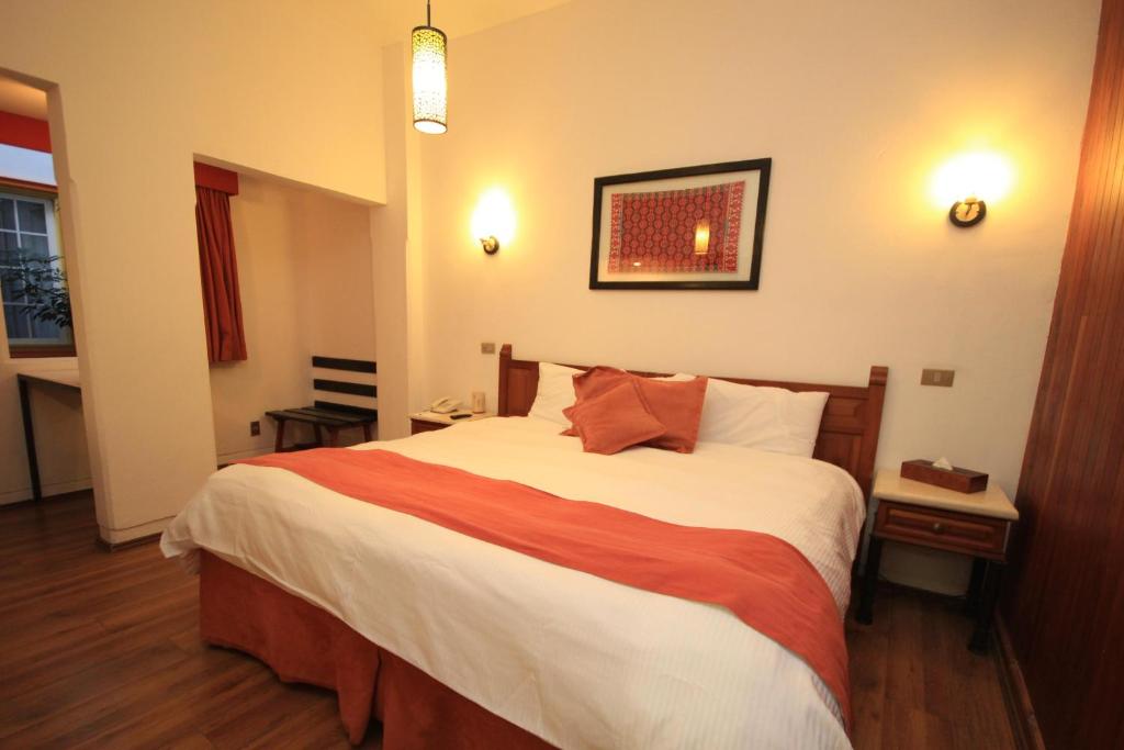 Postel nebo postele na pokoji v ubytování Hotel Ciudad Real Centro Historico