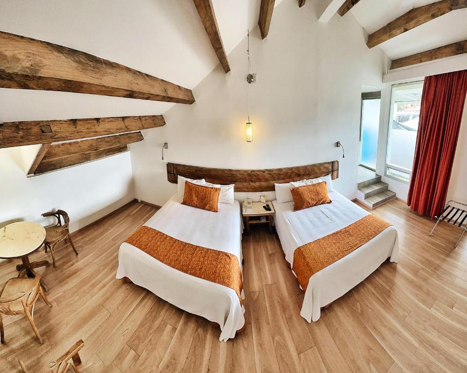 Postel nebo postele na pokoji v ubytování Hotel Ciudad Real Centro Historico