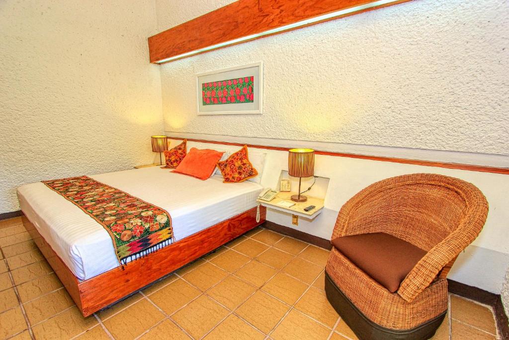Postel nebo postele na pokoji v ubytování Hotel Ciudad Real Palenque