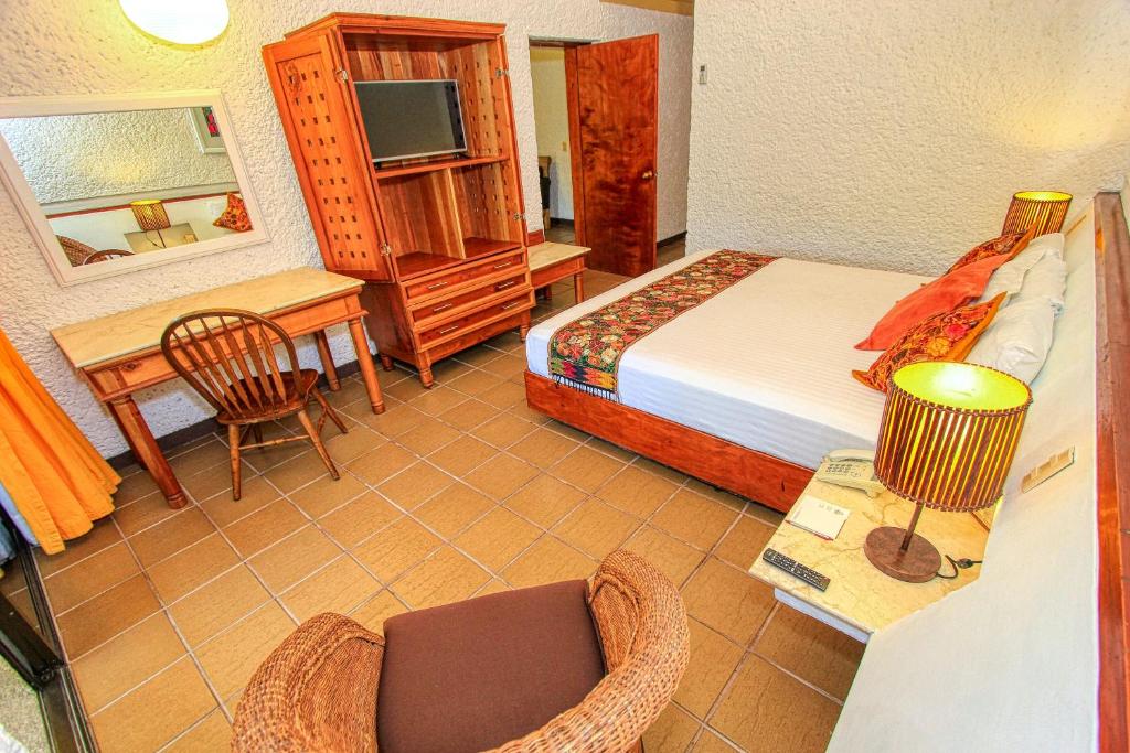 Postel nebo postele na pokoji v ubytování Hotel Ciudad Real Palenque