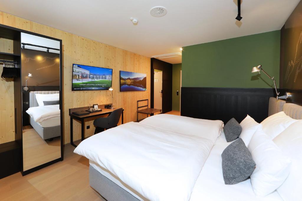 Postel nebo postele na pokoji v ubytování Hotel Steiermarkhof Graz - Aus Holz gebaut, von Hügeln geküsst