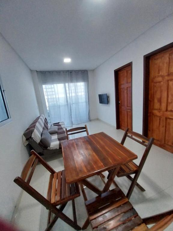 a living room with a table and chairs and a couch at Espaço Brisa do Mar in Olinda