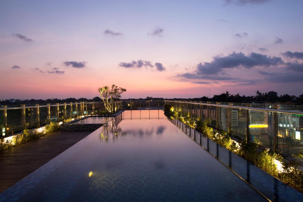 a view of a canal at night with lights at Hotel Santika Seminyak in Seminyak