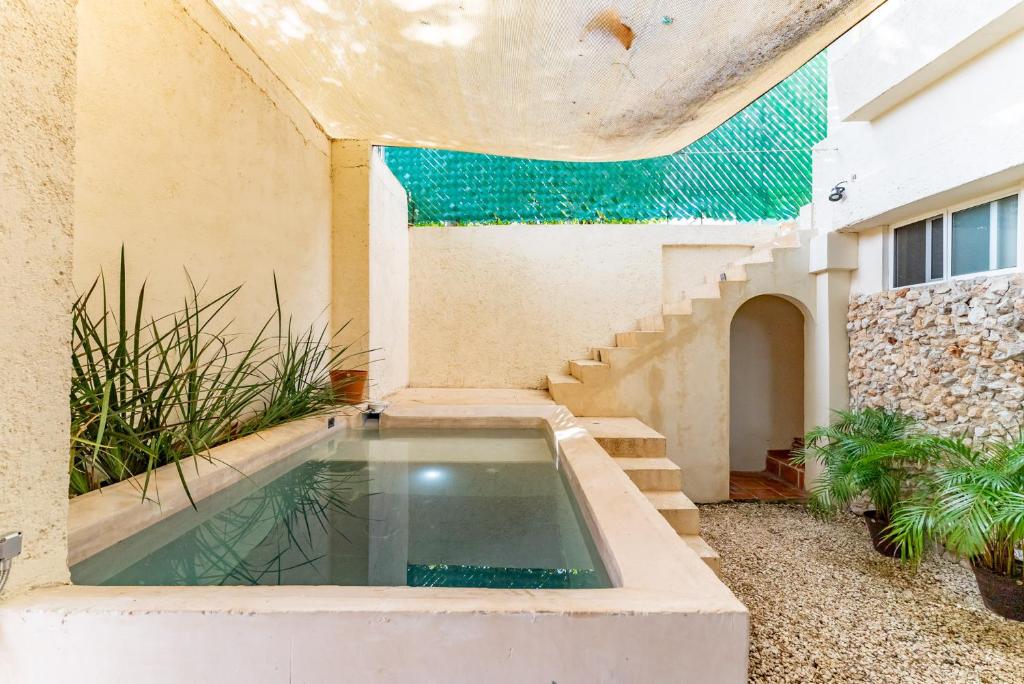 a swimming pool in the courtyard of a house at Casa Jicama in Cancún