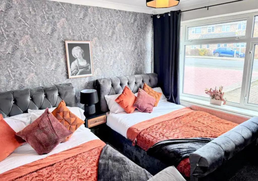 a bedroom with two beds and a window at Luxurious Retreat 4bd in Maidstone in Kent