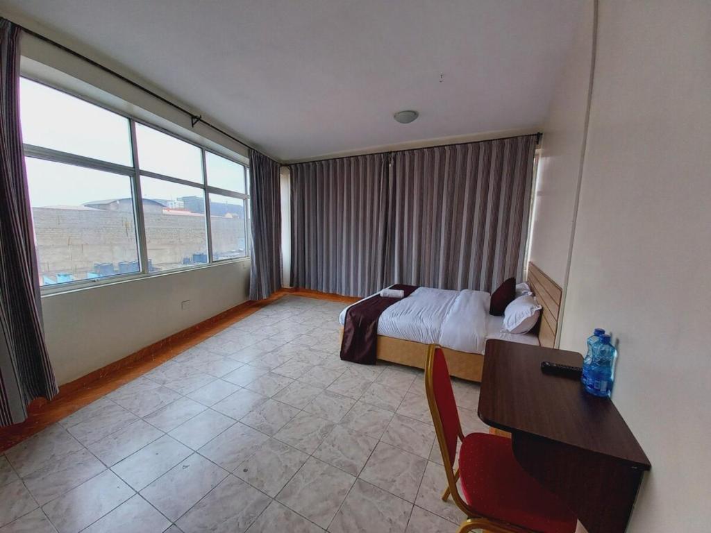 Postel nebo postele na pokoji v ubytování Fahari Bliss Hotel