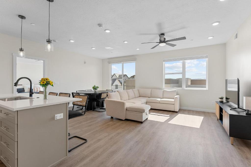 a white living room with a couch and a table at Cactus Blossom Oasis condo in Atkinville