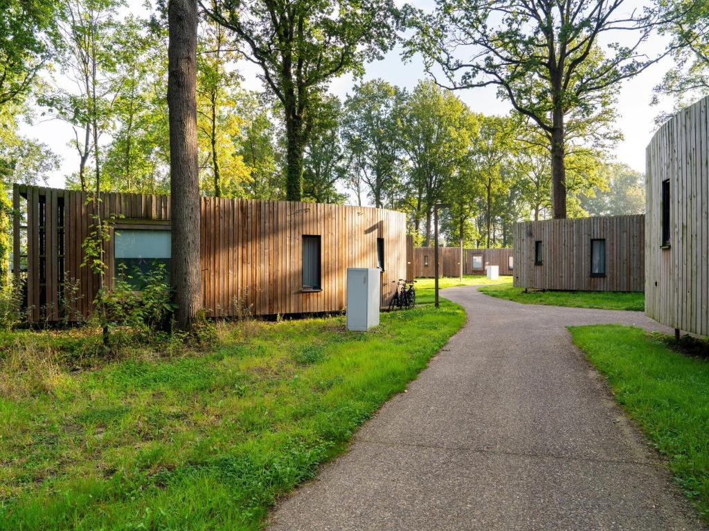 a house with wooden walls and a path at Serene Retreat in Antoing in Antoing