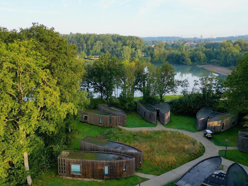 an aerial view of a group of cottages next to a lake at Lakeside Love Nest in Antoing