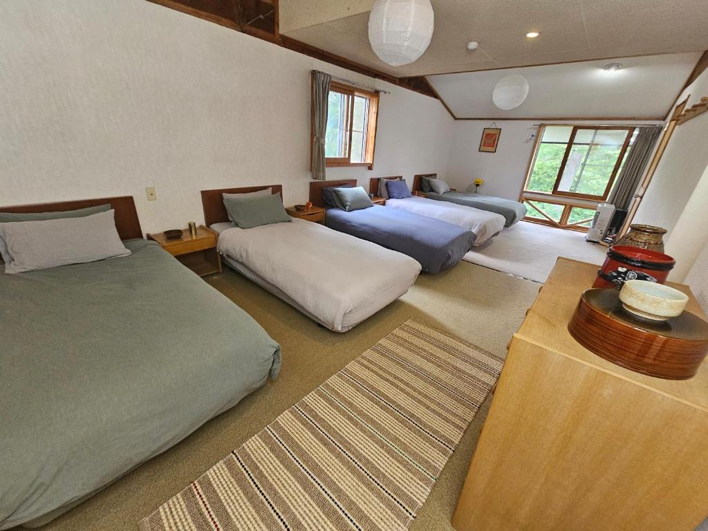 Postel nebo postele na pokoji v ubytování Yamadasan Ski Lodge - Madarao