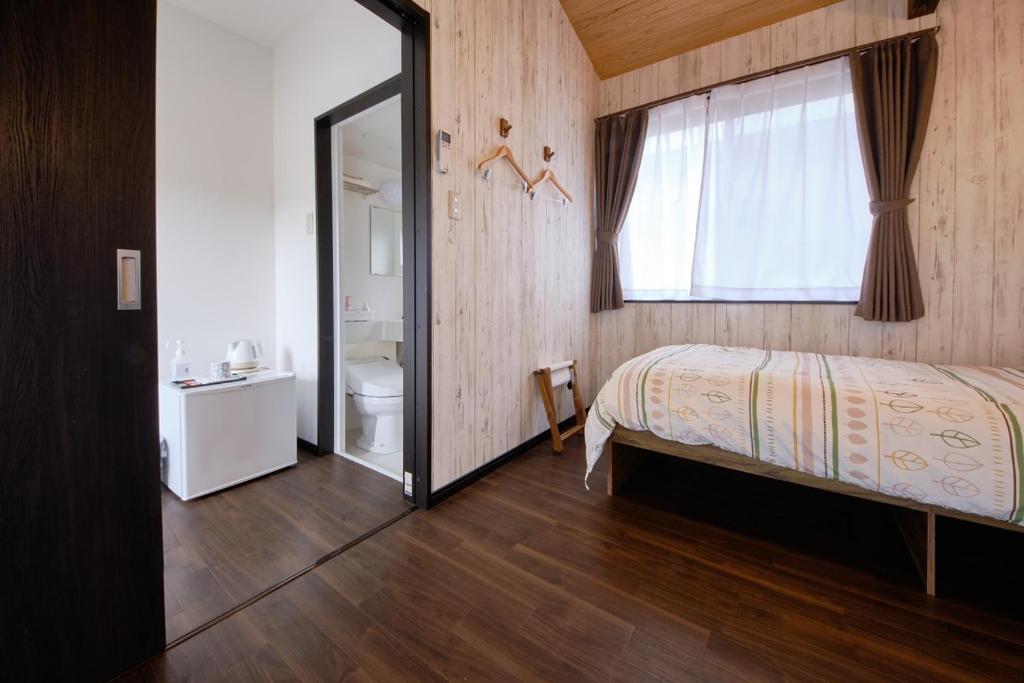 Postel nebo postele na pokoji v ubytování Cottage Kutsuroki
