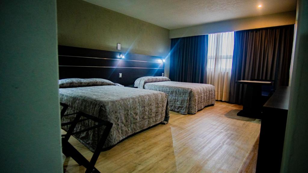 Postel nebo postele na pokoji v ubytování Hotel Parque Satelite