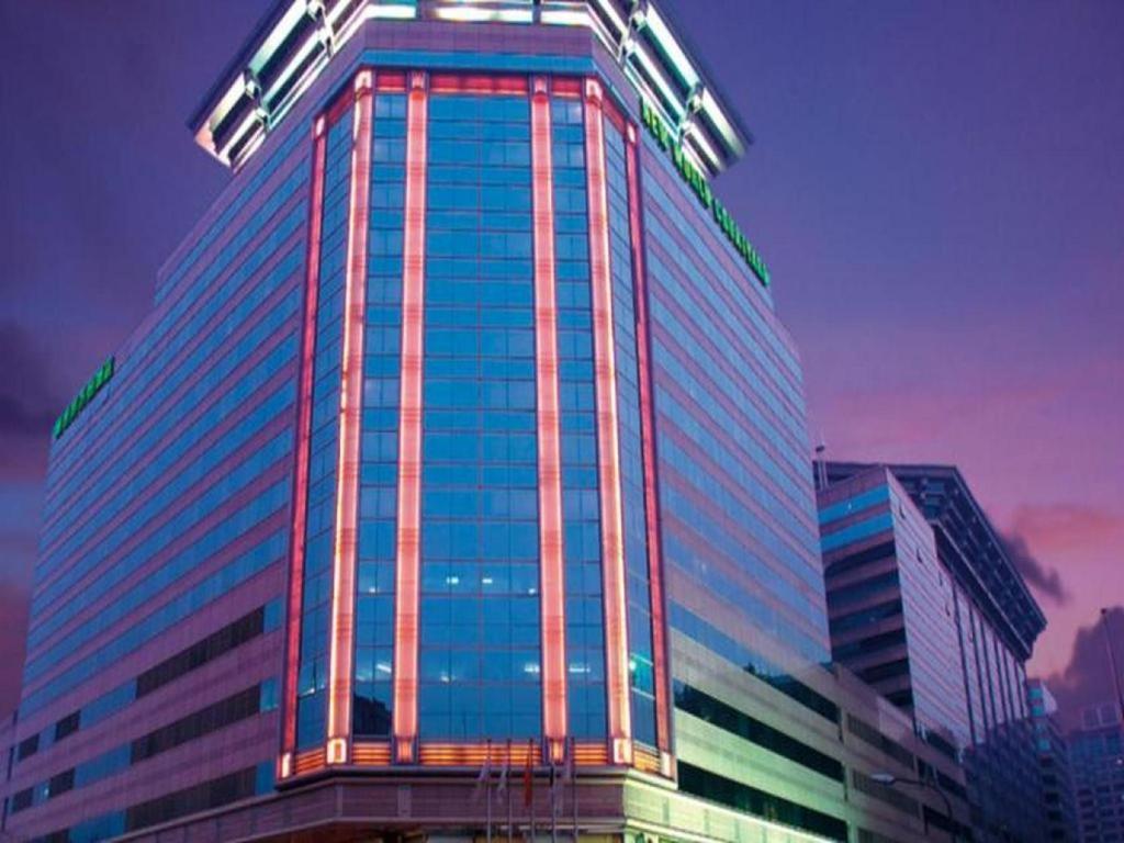 a tall building with lights on the side of it at Beijing New World Center Tongpai Hotel in Beijing