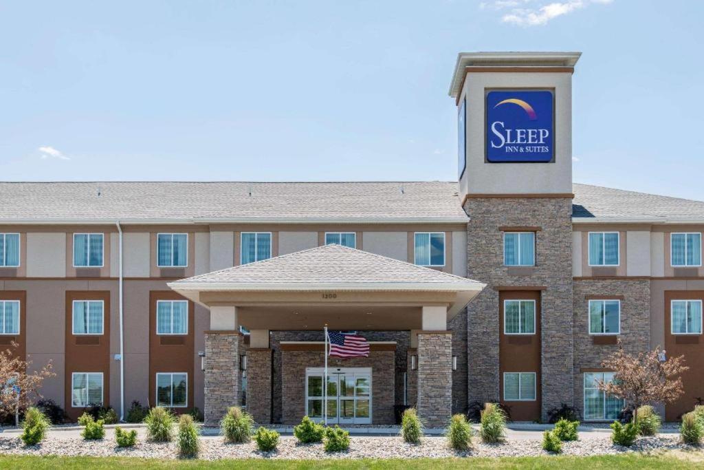 een hotel met een Amerikaanse vlag ervoor bij Sleep Inn & Suites Marshall - University Area in Marshall