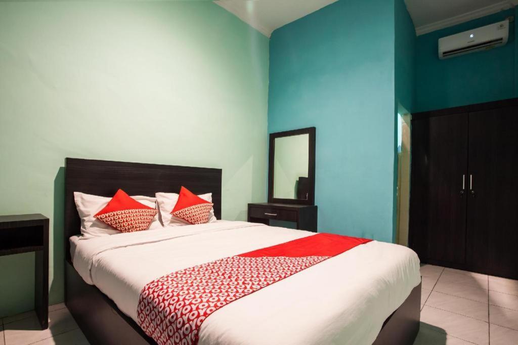 Postel nebo postele na pokoji v ubytování Hotel O Bunga Raya Residence