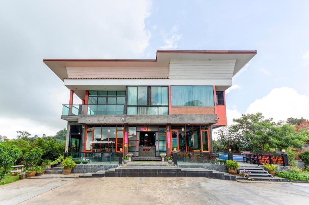 a large building with a lot of windows at OYO 1012 Vintage Home in Mae Salong