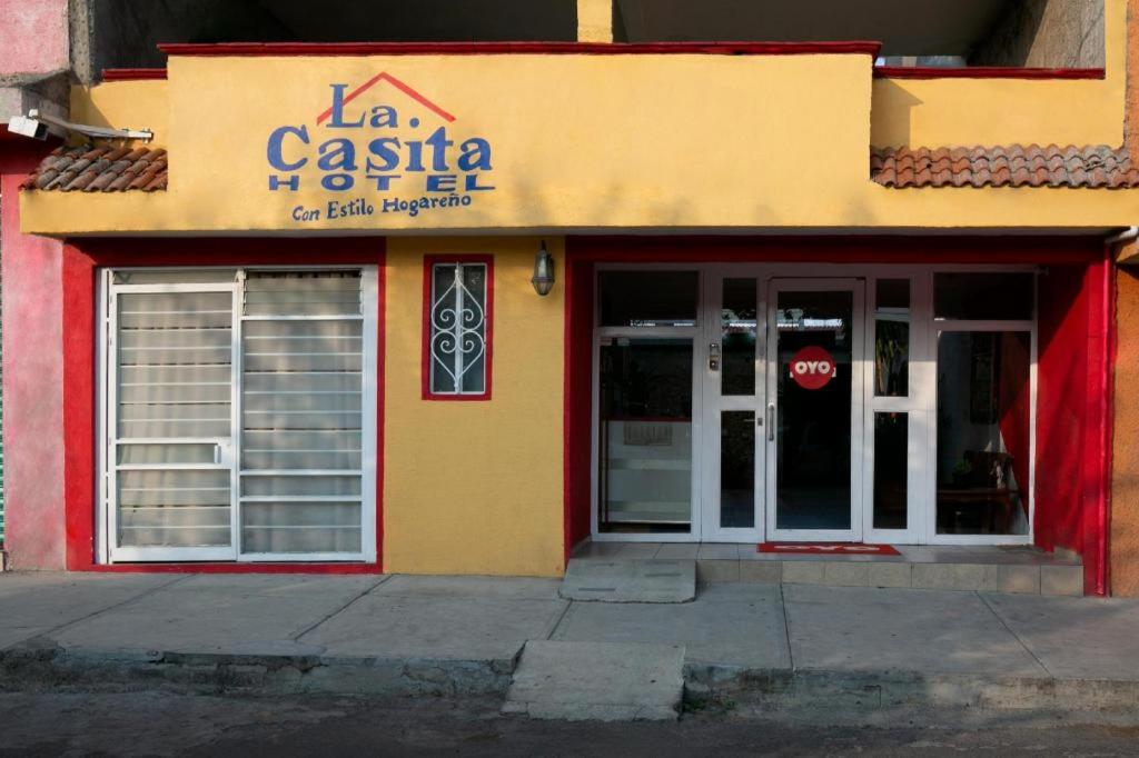 a restaurant with a red and yellow building at OYO La Casita in Quinceo