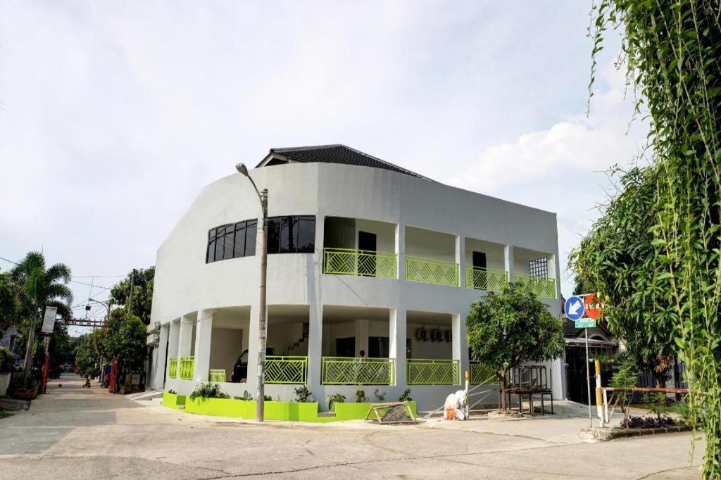 a white building with a lot of windows at Capital O 92804 La Tansa Syariah Hotel in Bekasi