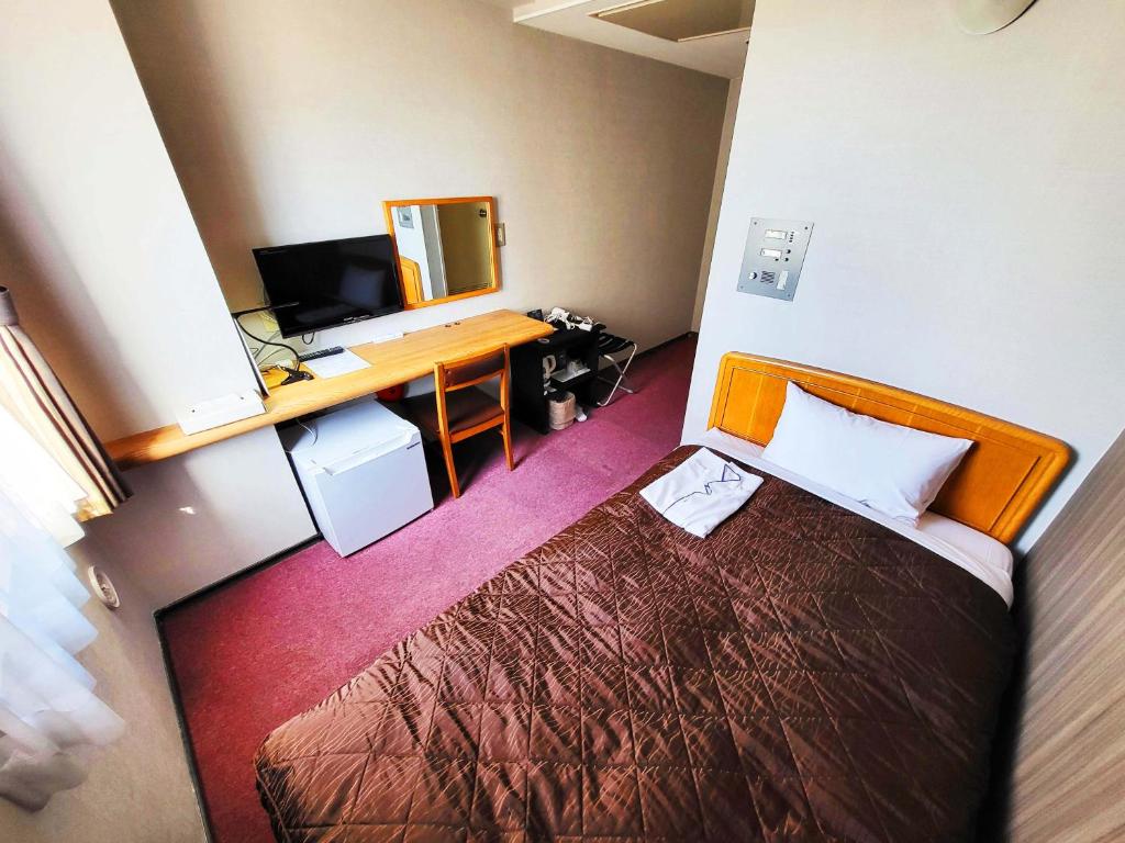 Postel nebo postele na pokoji v ubytování Hotel Royal Garden Kisarazu