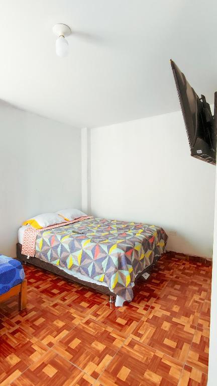 Postel nebo postele na pokoji v ubytování CASA RICARDO PALMA con PISCINA