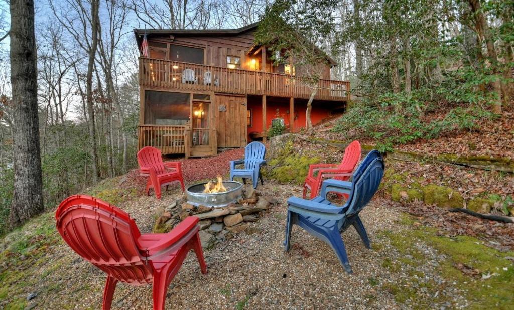 a group of chairs sitting in front of a cabin at American Dream Americana decor close to downtown Blue Ridge in Blue Ridge